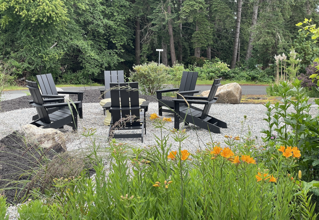 New outdoor fire pit area with 6 black adirondack chairs